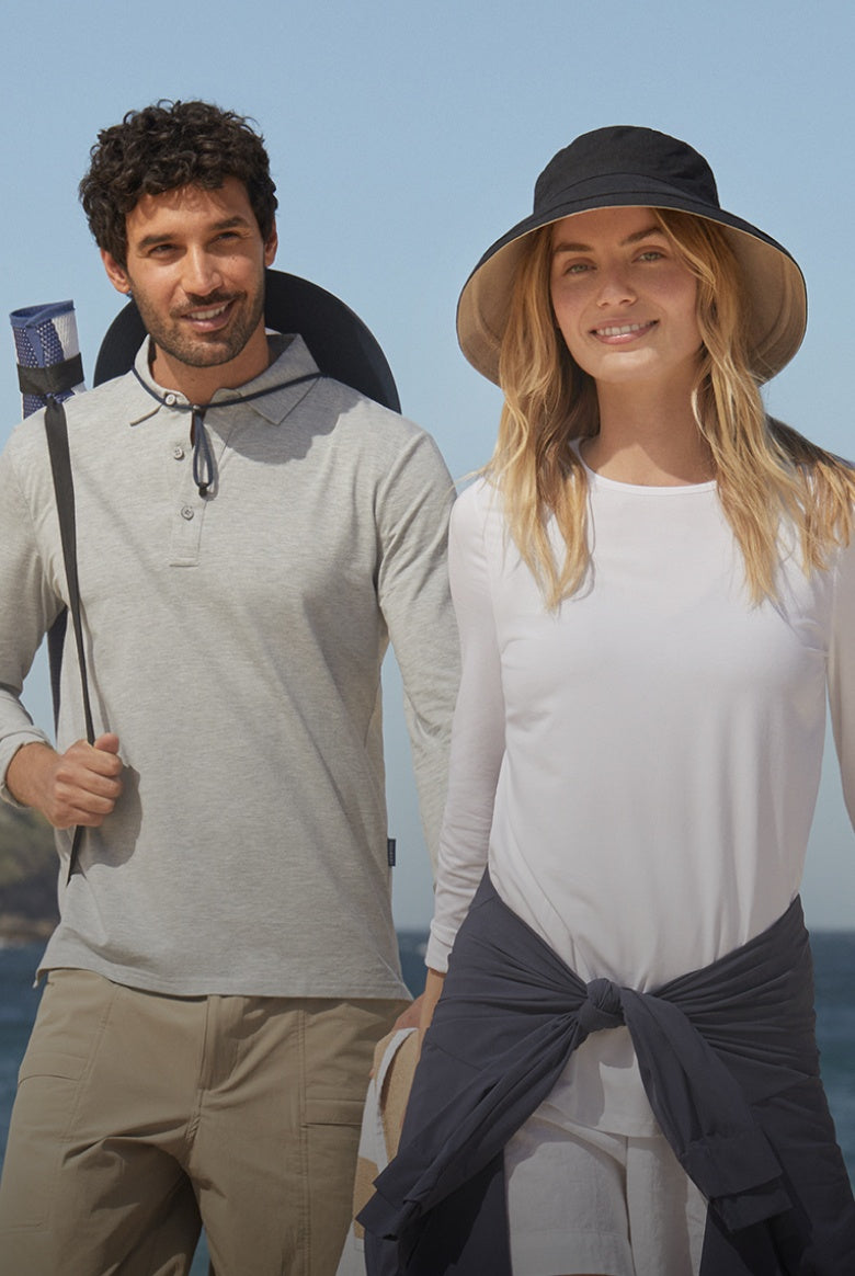 Man and woman standing on a beach with ocean view