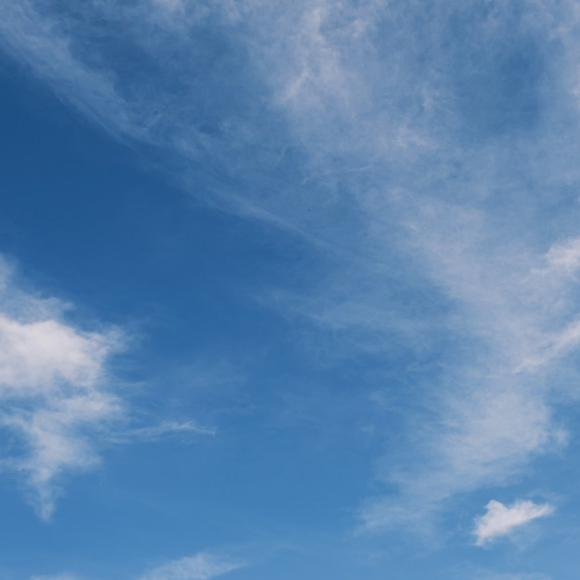 Blue sky with scattered white clouds